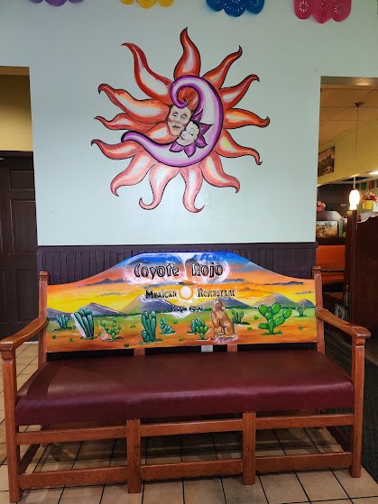 A booth painted with a desert scene, under the sun mural