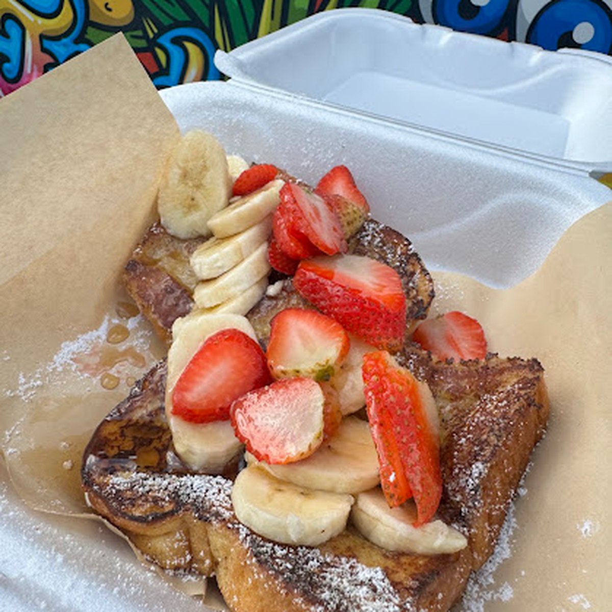 French toast with strawberries, banana and powdered sugar