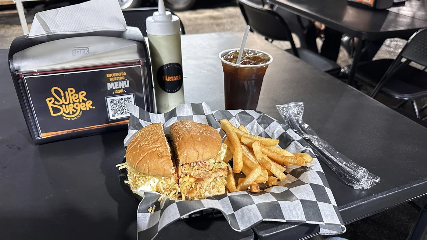 Burger and fries on a table at Super Burger.