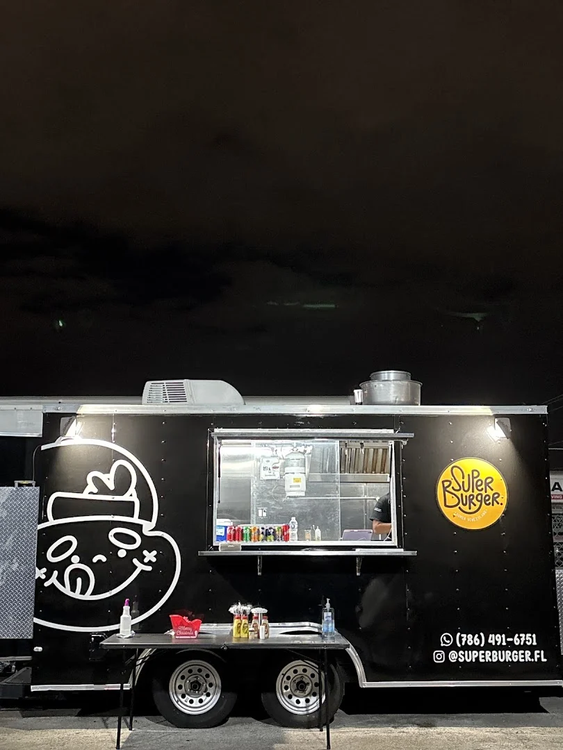 The black Super Burger food truck at night.